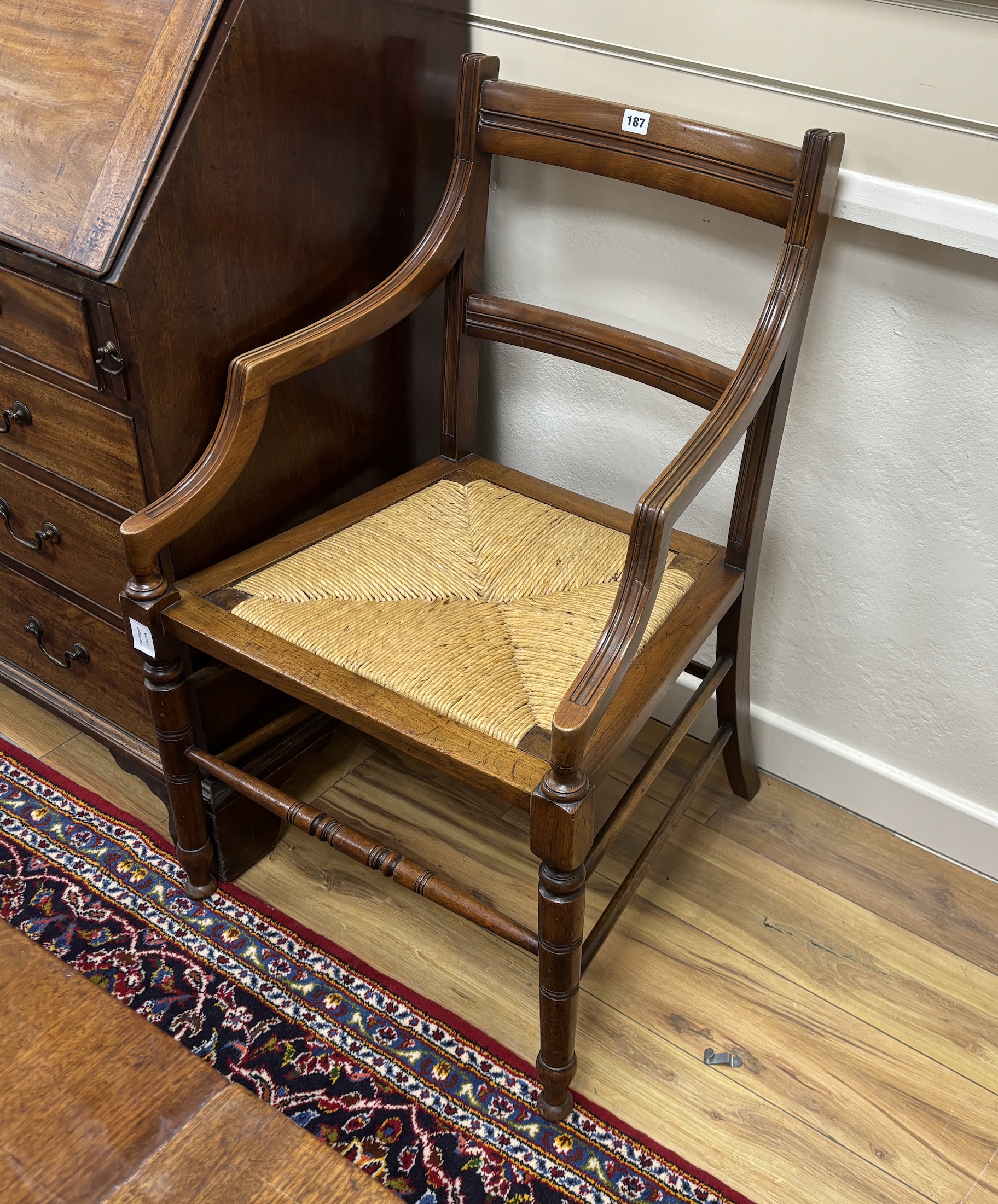 A pair of late Victorian Arts & Crafts mahogany rush seat elbow chairs, width 53cm, depth 49cm, height 94cm